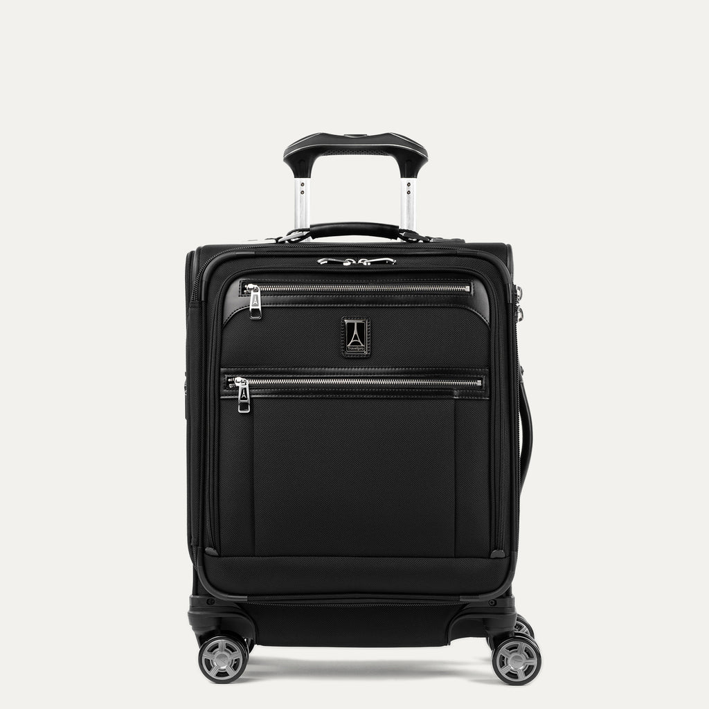 front hero view of the shadow black travelpro platinum® elite international carry-on spinner, showing the high-density fabric, dual front zippered pockets, leather trim, and the powerscope extension handle.