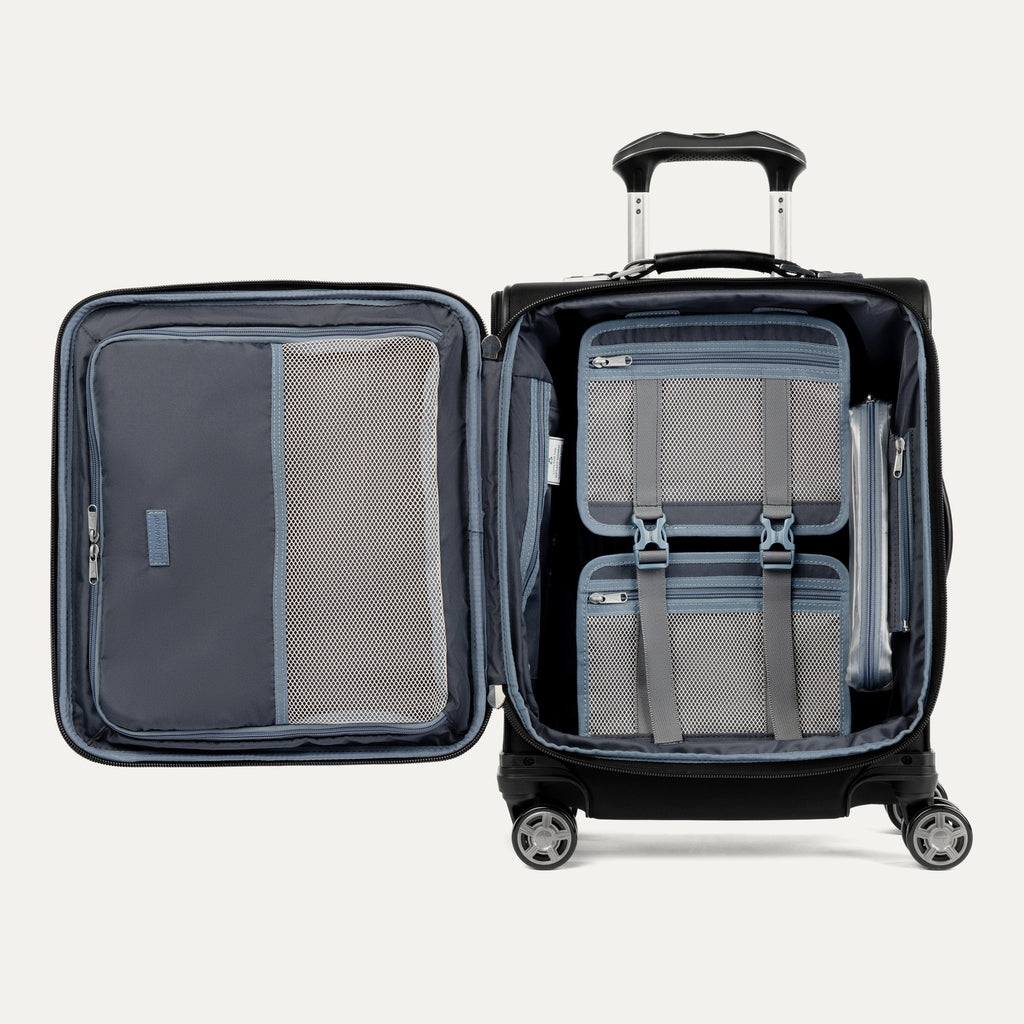 open interior view of the shadow black travelpro platinum® elite international carry-on spinner, showing the grey ecofab™ recycled lining, accessory pockets, and a removable tsa-compliant quart-size wet pocket.