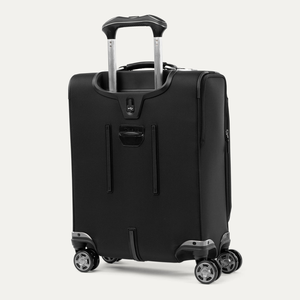 rear-angled view of the shadow black travelpro platinum® elite international carry-on spinner, showing the external usb port with flip cover, the integrated power bank pocket, and the adjustable powerscope extension handle.