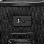 extreme close-up view of the external usb port on the shadow black travelpro platinum® elite international carry-on spinner, showing the sliding port cover and the embossed travelpro logo on the surrounding fabric.