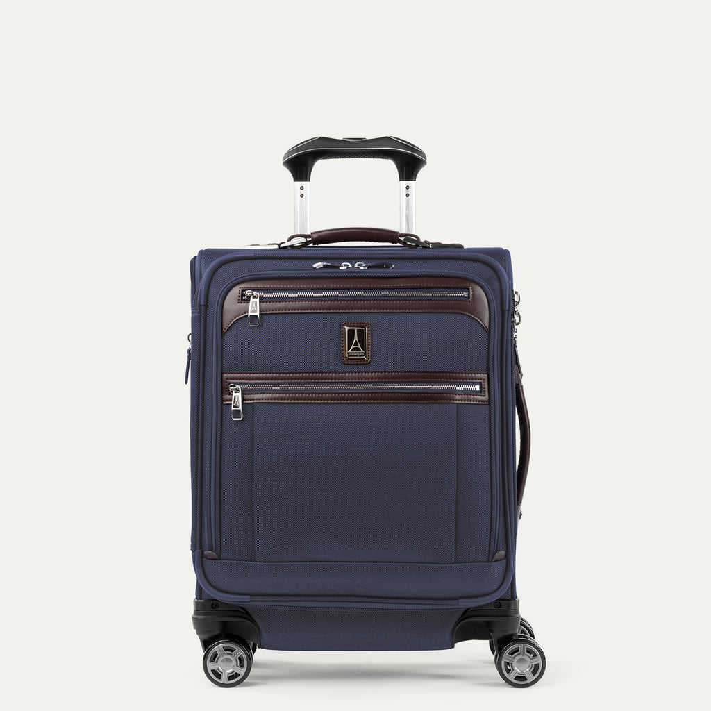Front view of Travelpro Platinum Elite International Expandable Carry-On Spinner in True Navy, featuring genuine leather accents and the adjustable PowerScope extension handle.