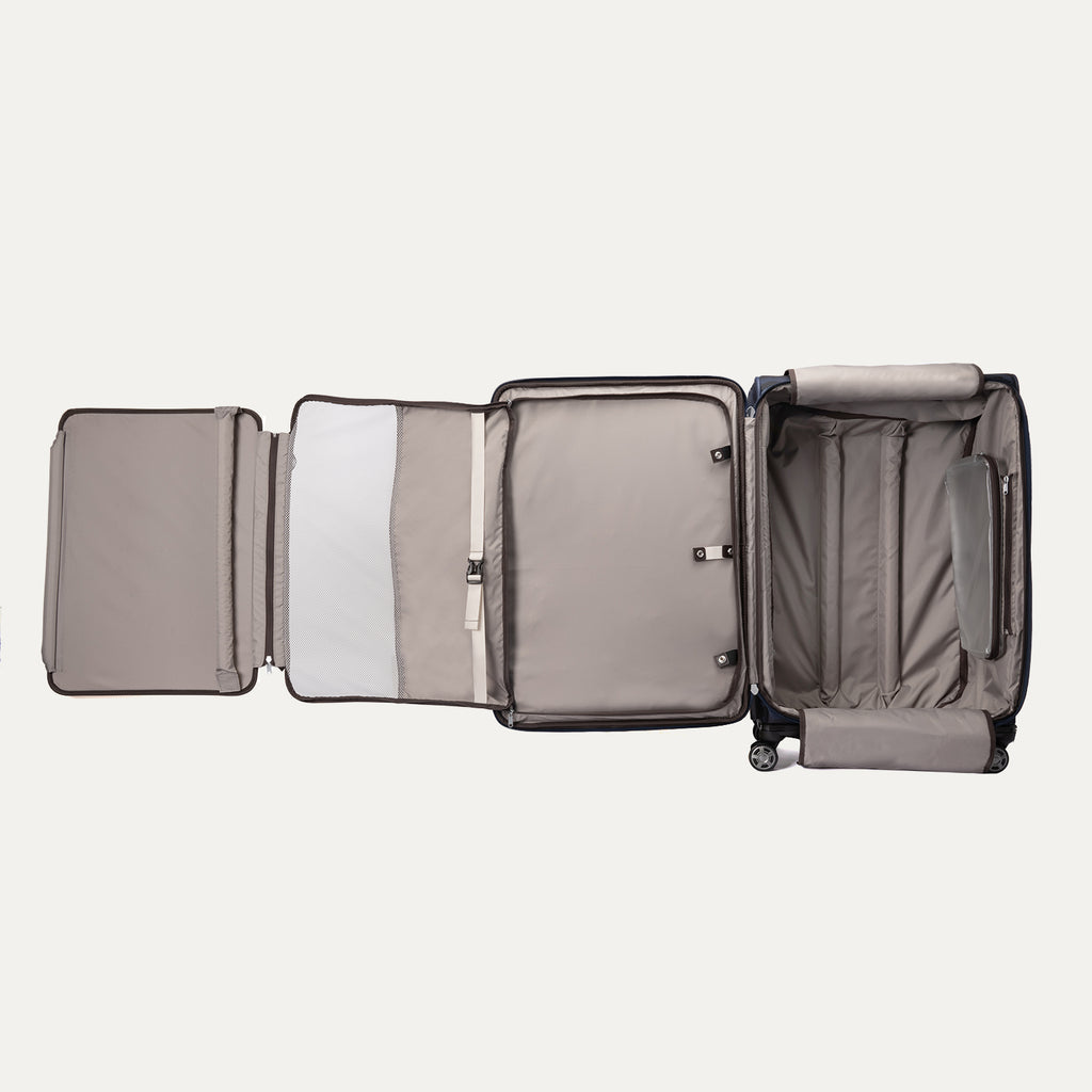 
fully opened interior view of the navy camouflage travelpro platinum elite large check-in spinner, showing the light grey ecofab lining, zippered mesh divider, built-in suiter, and adjustable tie-down straps with accessory pockets.