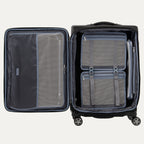 interior packing view of the open shadow black travelpro platinum elite medium check-in spinner, showing the dual-sided organization with a zippered mesh divider on one side and a deluxe tie-down system with accessory pockets on the other.