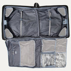 close-up interior view of the shadow black travelpro platinum® elite rolling garment bag, showing the padded roll bar and the heavy-duty hanger clamp designed to secure multiple suits or dresses and prevent wrinkling during travel.