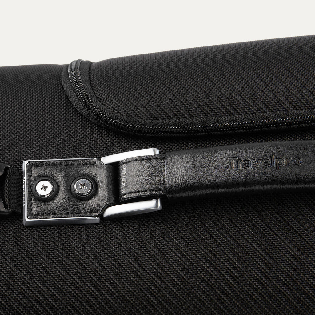 close-up view of the premium leather top carry handle on the shadow black travelpro platinum® elite rolling garment bag, showing the embossed travelpro logo and durable chrome-finished hardware.