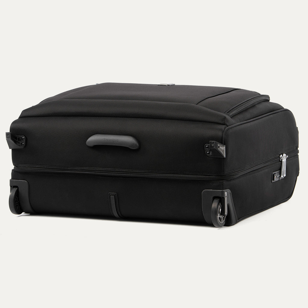 side and bottom view of the shadow black travelpro platinum® elite rolling garment bag, showing the two high-performance ball-bearing wheels, protective wheel housings, and the bottom stabilizer bar that keeps the bag upright.