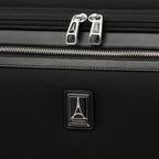 close-up view of the shadow black travelpro platinum® elite rolling garment bag, showing two silver-tone chrome zipper pulls with the travelpro logo and a matching metal travelpro emblem on the textured black fabric.