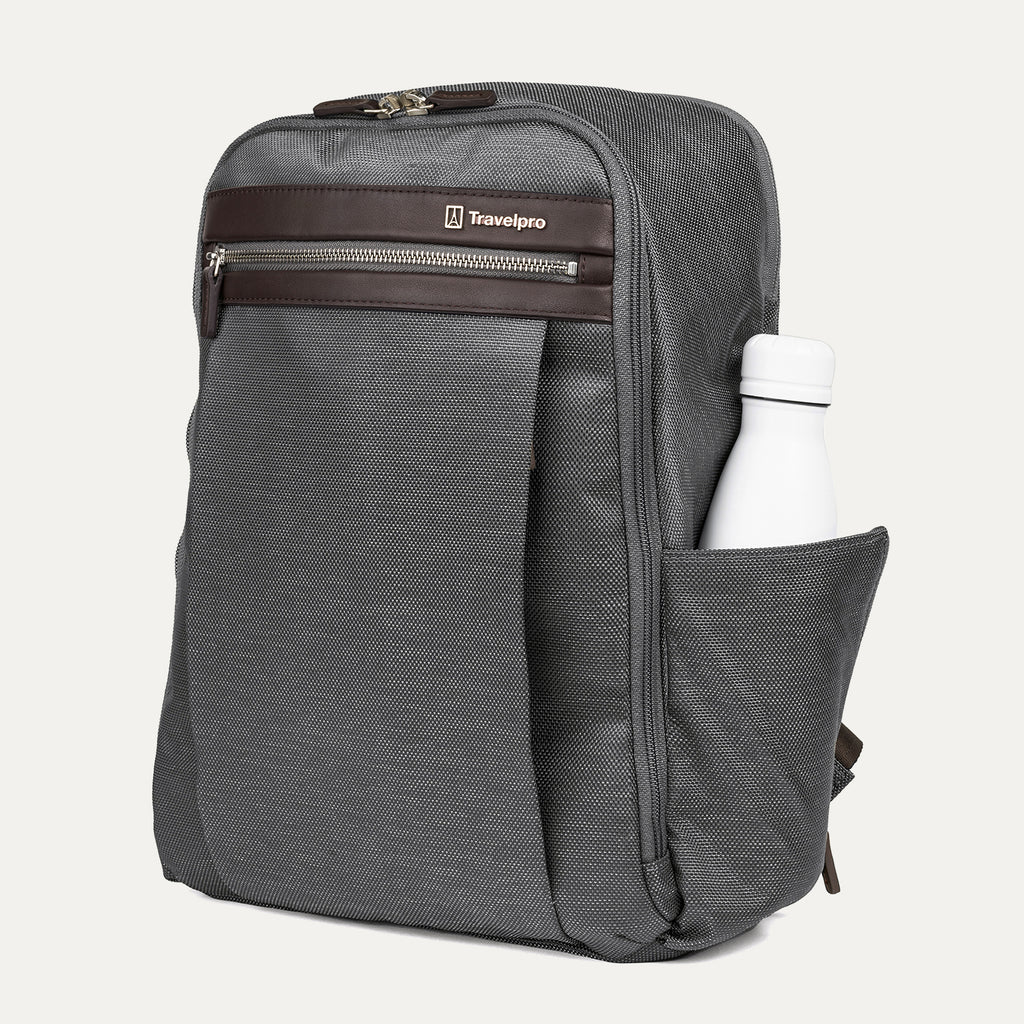 side profile of the vintage grey travelpro platinum® elite slim laptop backpack 16l, showing a white reusable water bottle tucked into the integrated side pocket with dark brown leather trim.