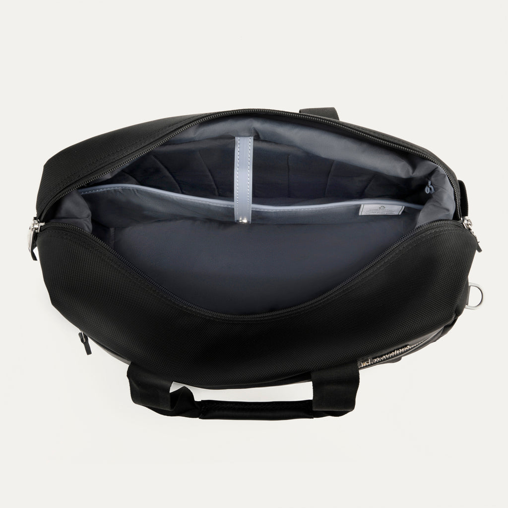 interior view of the open black travelpro platinum elite underseat tote, showing the spacious main compartment with a grey lining and a small leather-trimmed internal pocket.