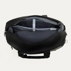 interior view of the open black travelpro platinum elite underseat tote, showing the spacious main compartment with a grey lining and a small leather-trimmed internal pocket.