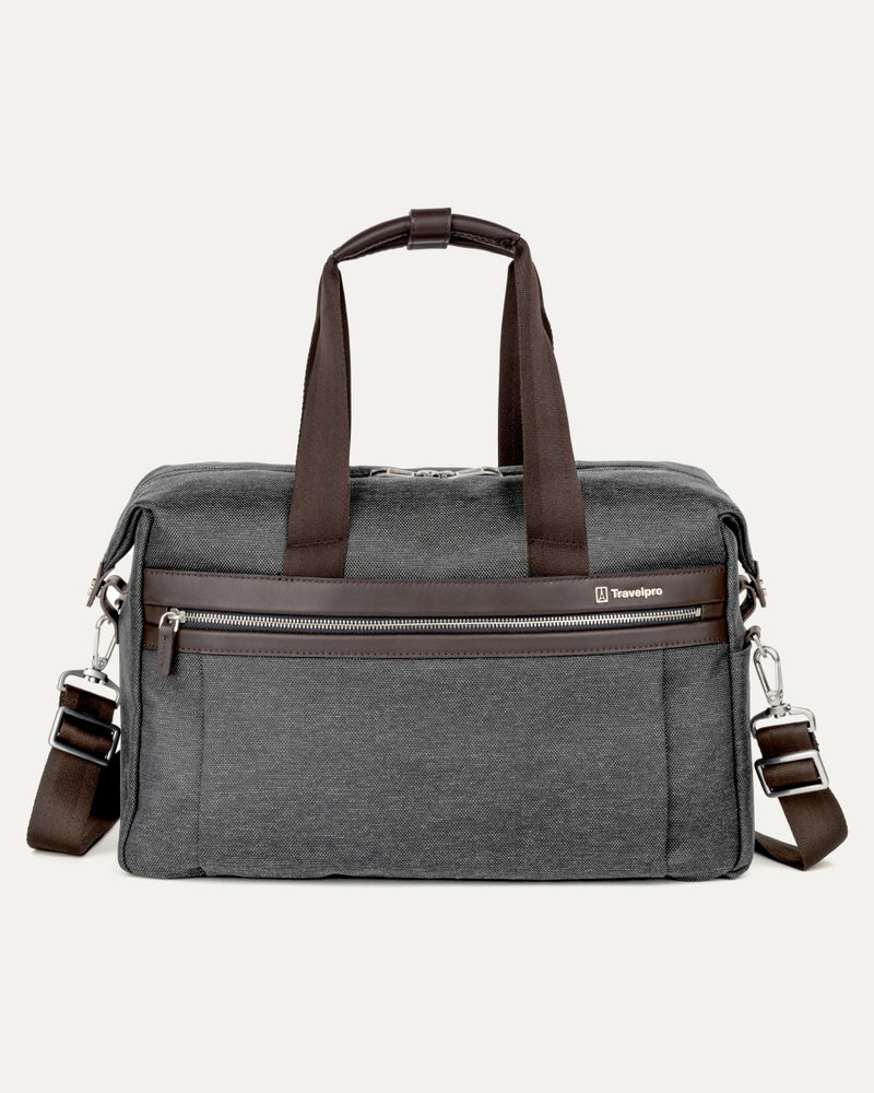front view of the vintage grey travelpro platinum elite underseat tote featuring a textured grey fabric, brown leather trim and handles, chrome hardware, and a removable shoulder strap.
