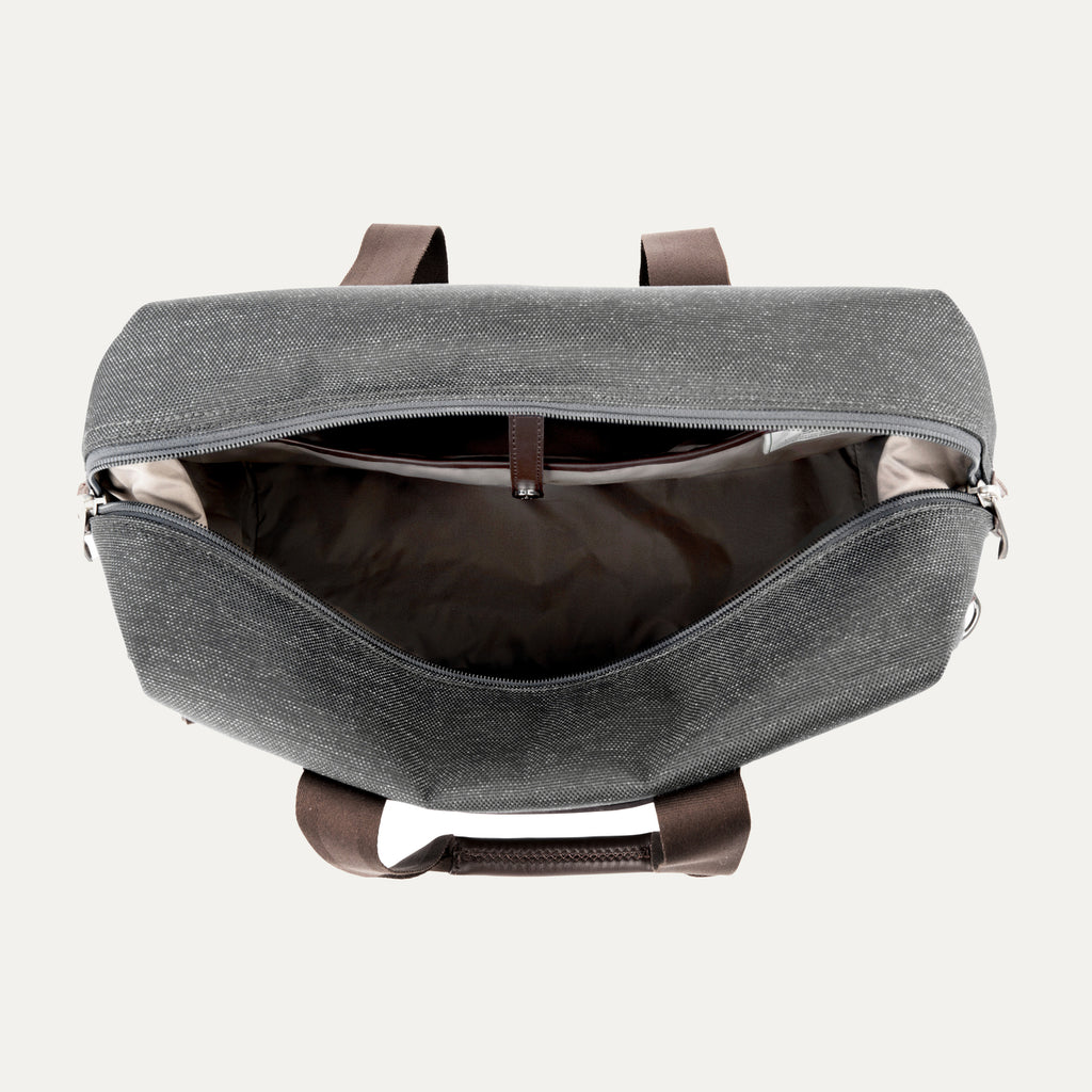 interior view of the open vintage grey travelpro platinum elite underseat tote, showing the spacious main compartment with a tan lining and small internal storage pockets.
