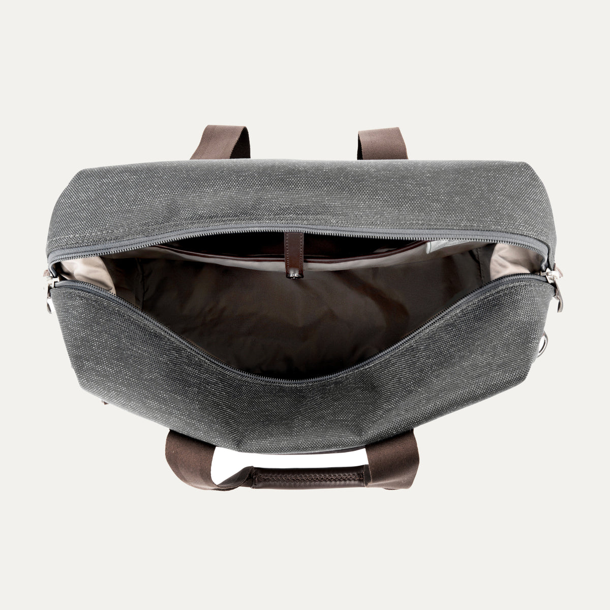 interior view of the open vintage grey travelpro platinum elite underseat tote, showing the spacious main compartment with a tan lining and small internal storage pockets.