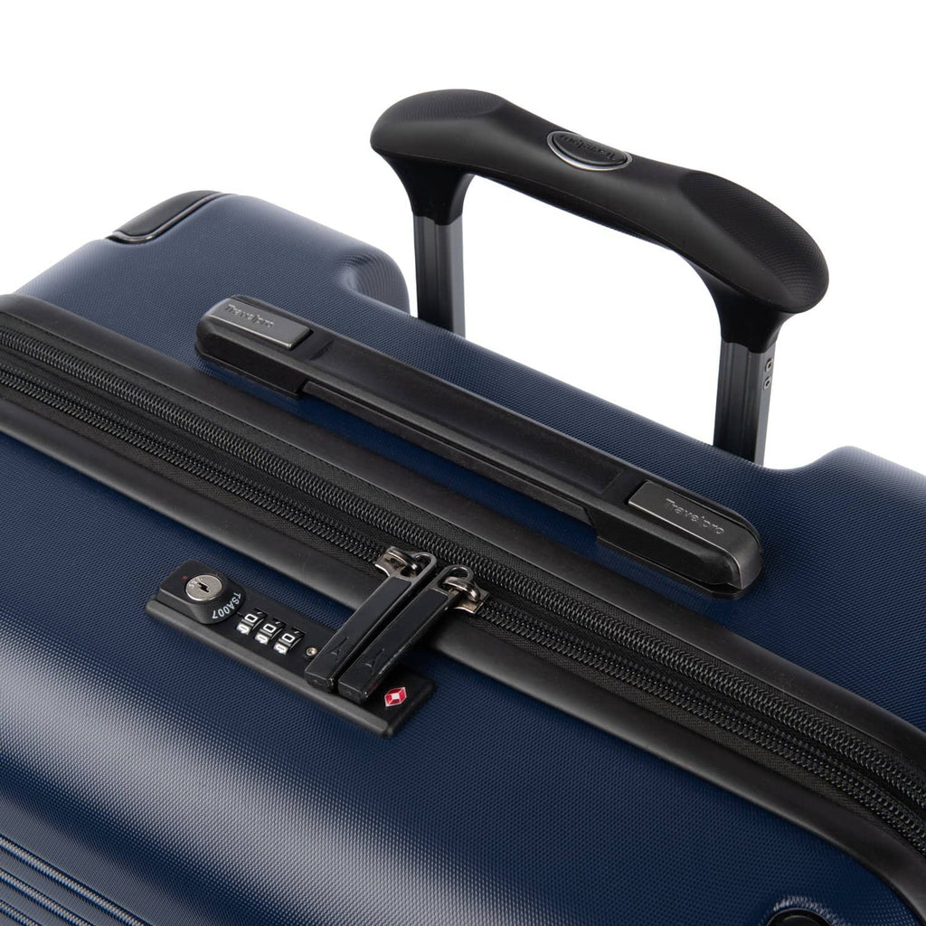 Close‑up of Travelpro Roundtrip Medium Check‑In Expandable Spinner in Navy, showing TSA‑approved lock, zipper pulls, and black telescoping handle on textured hardshell design against white background.