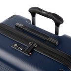 Close‑up of Travelpro Roundtrip Medium Check‑In Expandable Spinner in Navy, showing TSA‑approved lock, zipper pulls, and black telescoping handle on textured hardshell design against white background.
