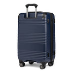 Rear view of Travelpro Roundtrip Medium Check‑In Expandable Spinner in Navy, showing textured hardshell design, black telescoping handle, and four spinner wheels against white background.