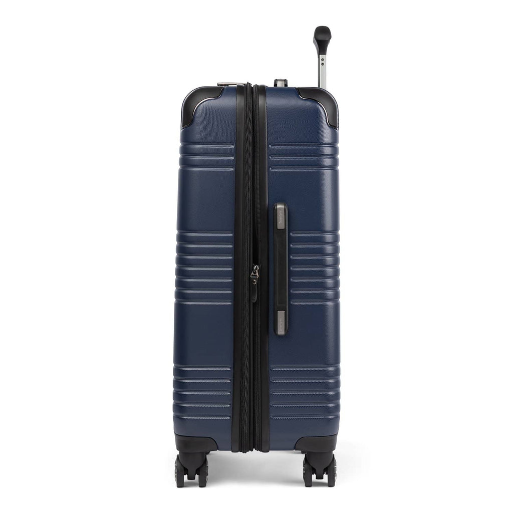 Side view of Travelpro Roundtrip Medium Check‑In Expandable Spinner in Navy, showing textured hardshell design, expansion zipper open, black telescoping handle, and four spinner wheels against white background.